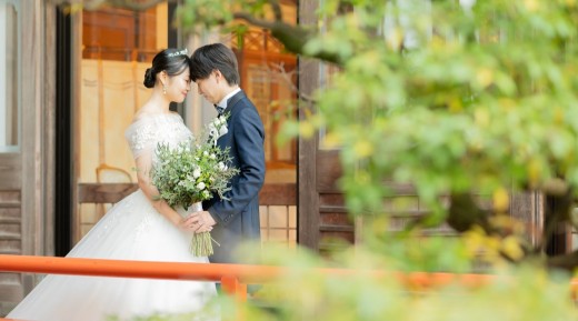 奈良ホテルの庭でおでこを合わせる新郎新婦
